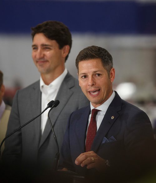 MIKE DEAL / WINNIPEG FREE PRESS
Prime Minister Justin Trudeau looks on while Winnipeg Mayor Brian Bowman talks during a press conference at a new 700 employee Canada Goose manufacturing facility in Winnipeg. 
180911 - Tuesday, September 11, 2018.