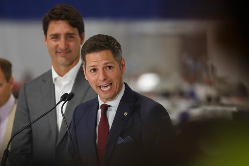 MIKE DEAL / WINNIPEG FREE PRESS
Prime Minister Justin Trudeau looks on while Winnipeg Mayor Brian Bowman talks during a press conference at a new 700 employee Canada Goose manufacturing facility in Winnipeg. 
180911 - Tuesday, September 11, 2018.