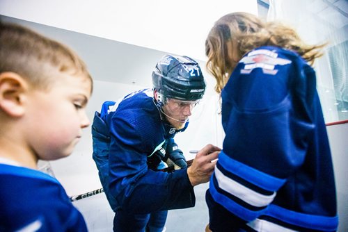 MIKAELA MACKENZIE / WINNIPEG FREE PRESS
Nikolaj Ehlers signs Emma Ortwein's jersey as her little brother, Liam, watches at the MTS Iceplex in Winnipeg on Wednesday, Sept. 12, 2018.  
Winnipeg Free Press 2018.