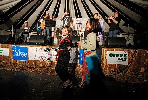 BORIS MINKEVICH / WINNIPEG FREE PRESS 090219 Calista St. Hilaire,9, and Angeleka Bisson,9, dance to the sweet sounds of Winnipeg french music band called Les Soeurs Valades in the Sugar Shack on festival grounds.