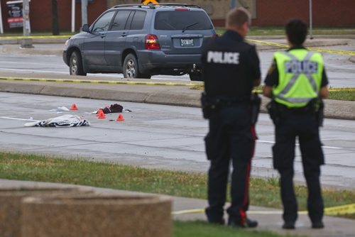 MIKE DEAL / WINNIPEG FREE PRESS
Police document the scene after a pedestrian was sent to the hospital after being hit by a vehicle while crossing St. Annes Road at Aldgate Road. 
180913 - Thursday, September 13, 2018