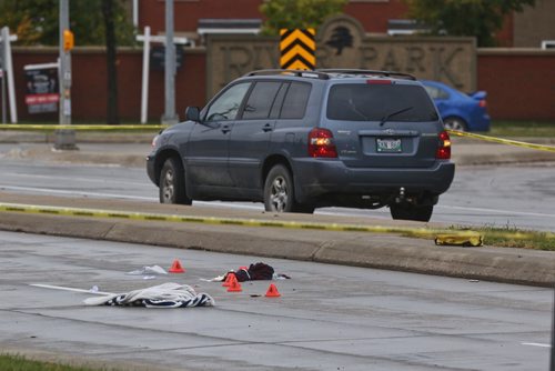 MIKE DEAL / WINNIPEG FREE PRESS
Police document the scene after a pedestrian was sent to the hospital after being hit by a vehicle while crossing St. Annes Road at Aldgate Road. 
180913 - Thursday, September 13, 2018