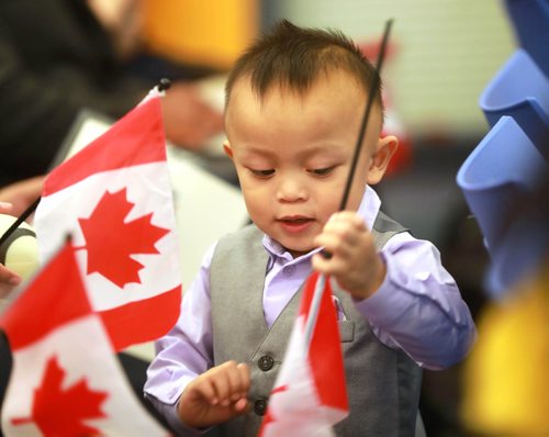 RUTH BONNEVILLE / WINNIPEG FREE PRESS 


Standup photo 
Two-year-old Justin Warli Calico waves his older brothers Canadian flag  after his family became Canadian Citizens at  a formal ceremony which welcomed 21 new citizens  at The Winnipeg Police Service HQ Thursday.

His older brothers, Julius (10yrs), Joshua (8yrs) mom and dad, also became citizens Thursday.  

September 12/18 

