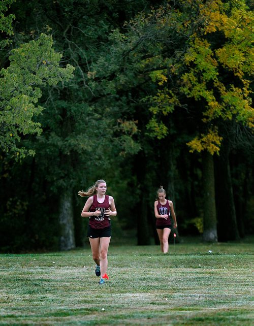 PHIL HOSSACK / WINNIPEG FREE PRESS - Jr Varsity Girls Cross Country Runners work their way across the LaSalle RIver and around LaBarrier Park Thursday afternoon in- Sept 13, 2018