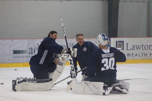 MIKE DEAL / WINNIPEG FREE PRESS
Winnipeg Jets' goaltenders Connor Hellebuyck (37) and Laurent Brossoit (30) with goaltender coach Wade Flaherty take a moment during training camp.
180914 - Friday, September 14, 2018.
