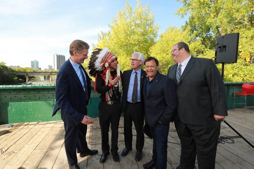 RUTH BONNEVILLE / WINNIPEG FREE PRESS 


The Government of Canada announces support for acquisition and repair of Churchill rail line by Arctic Gateway Group at press conference  held on the Forks historic bridge Friday.

Key players in attendance stand together for a group photo after presser.  Names from left: 
Fairfax President Paul Rivett, Grand Chief Arlen Dumas, 
MP Jim Carr (Minister of International Trade Diversification), mayor of Churchill Mike Spence and AGT Food Inc. director of corporate affairs Omer Al-Katib. 

See Martin Cash story. 

September 14/18 
