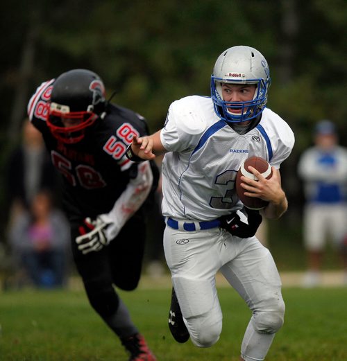 PHIL HOSSACK / WINNIPEG FREE PRESS - Oak Park Raider's QB  #3 Thomas Hubbard runs the ball leaving Sisler Spartan #58 Eric Heigle in his wake Friday afternoon as the teams met at Oak Park's field. - Sept 14, 2018