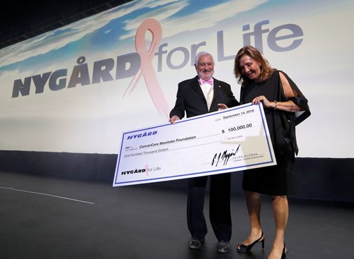 JASON HALSTEAD / WINNIPEG FREE PRESS

President and CEO of Nygard Fashions at Nygard International Jim Bennett presents a donation of $100,000 to CancerCare Manitoba president and CEO Annitta Stenning at the Nygard 50 Years in Fashion gala at the RBC Convention Centre Winnipeg on Sept. 14, 2018. (See Prest story)