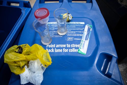 ANDREW RYAN / WINNIPEG FREE PRES Items which cannot be recycled placed on a bin to be moved to a garbage receptacle. Wilson went through Wolseley residents' recycling bins for misplaced items on July 26, 2018.
