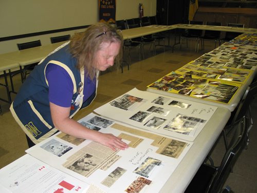 Canstar Community News Sept. 12, 2018 - Portage la Prairie Lions Club member and Zone 11 membership chair Anita Hart looks at the club's collection of photos and clippings commemorating the club's 80 years of service in the Portage la Prairie area. (ANDREA GEARY/CANSTAR COMMUNITY NEWS)