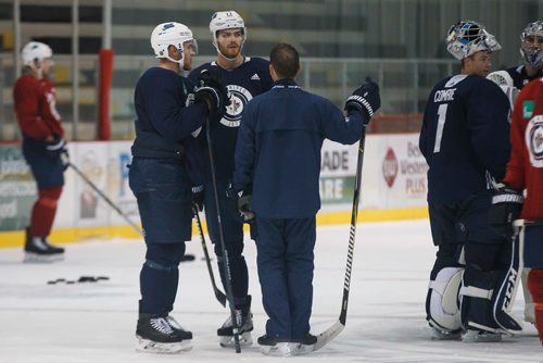 MIKE DEAL / WINNIPEG FREE PRESS
Winnipeg Jets' Adam Lowry (17) and Andrew Copp (9) talk to assistant coach Todd Woodcroft during training camp Wednesday morning at the BellMTS Iceplex.
180919 - Wednesday, September 19, 2018.