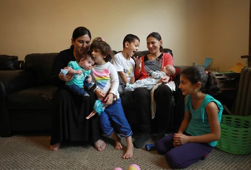 RUTH BONNEVILLE / WINNIPEG FREE PRESS 

LOCAL - 49.8 Feature
Photos of Yazidi moms, their kids and new babies taken in one of the moms home.  For feature on the ethnocultural group that faced genocide in northern Iraq having children and growing families here in Winnipeg- they went from escaping death at hands of ISIS to producing new life as refugees in a safe place. 

Names:
Safiya Maroo (right in pinkish sweater) with her 3 kids. One girl (Madleen, 7yrs old), 2 boys, Salam who is 51/2 yrs and Sam who is 3 weeks.
 
Second mom is Basima Grnos  holding her baby girl, Avin, 2 weeks ago with her older daughter Navin (41/2 yrs) next to her (blue pants). 
 
Carol Sanders  | Reporter


September 19/18 
