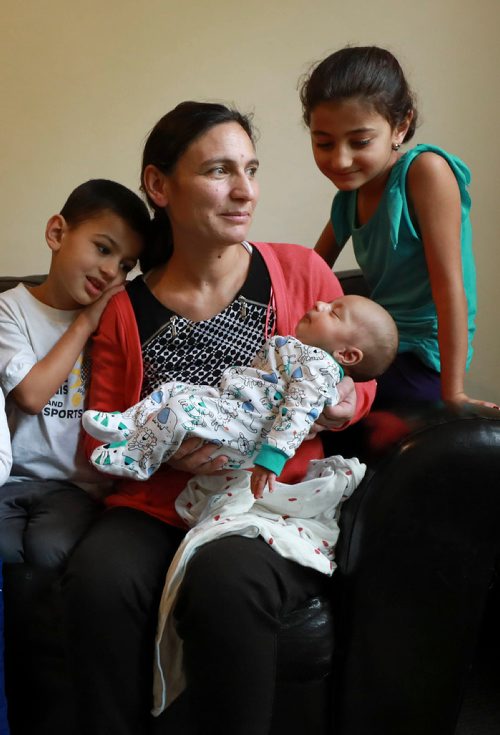 RUTH BONNEVILLE / WINNIPEG FREE PRESS 

LOCAL - 49.8 Feature
Portrait of of Yazidi mom with her kids and new baby taken Safiya Maroo's home.   For feature on the ethnocultural group that faced genocide in northern Iraq having children and growing families here in Winnipeg- they went from escaping death at hands of ISIS to producing new life as refugees in a safe place. 

Names:
Mom, Safiya Maroo  with her 3 kids. One girl (Madleen, 7yrs old), 2 boys, Salam who is 51/2 yrs and Sam who is 3 weeks.
 

Carol Sanders  | Reporter


September 19/18 
