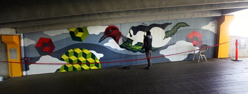 PHIL HOSSACK / WINNIPEG FREE PRESS - Toronto Artist Jerry Rugg works on a mural at the Forks Parkade Wednesday. Also known as 'Birdo', he's one of a group of artists taking part in the Wall to Wall Festival here in the city. See release? - Sept 19, 2018