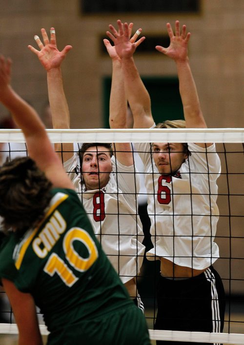 PHIL HOSSACK / WINNIPEG FREE PRESS - U of W Wesmen blockers #8 Will Racano and #6 Antanis Grigaitis go up in unison to challenge a hit by CMU # 10 John Niekartz Wednesday evening at CMU in exhibition play.. - Sept 19, 2018