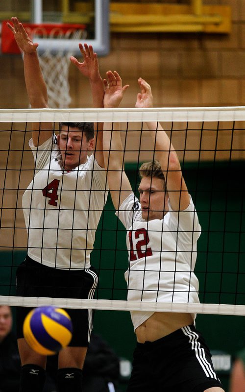 PHIL HOSSACK / WINNIPEG FREE PRESS - U of W Wesmen #4 Daniel Thiessen and #12 Garrett Jones send the ball back to the CMU Blazers court Wednesday evening at CMU in exhibition play.. - Sept 19, 2018
