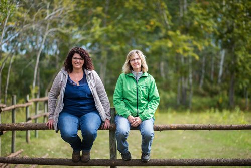 MIKAELA MACKENZIE / WINNIPEG FREE PRESS
Tracy Wood (left) and Taralea Simpson pose on a fence rail at Farm Away, just outside of Portage la Prairie, on Wednesday, Sept. 19, 2018.  
Winnipeg Free Press 2018.