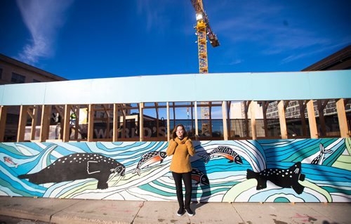 MIKAELA MACKENZIE / WINNIPEG FREE PRESS
Inuit artist Kailey Sheppard poses in front of her work on the on the pedestrian walkway outside the Winnipeg Art Gallery in Winnipeg on Friday, Sept. 21, 2018. The mural is titled "Mosaic Sea," and layers Inuit imagery through a collage-based process. Winnipeg Free Press 2018.