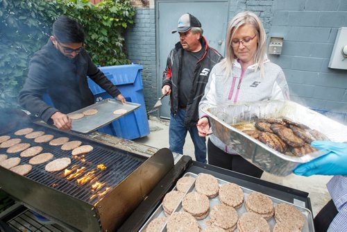 MIKE DEAL / WINNIPEG FREE PRESS
(from left) Asad Muhammad, Glen Urbanski, and Crystal Fear help out during a BBQ at the Lighthouse Mission  Saturday afternoon. Lighthouse Mission and the Exchange District Pharmacy hosted the BBQ in an effort to provide health information, advice, and resources to members of the city's neediest community.
180922 - Saturday, September 22, 2018.