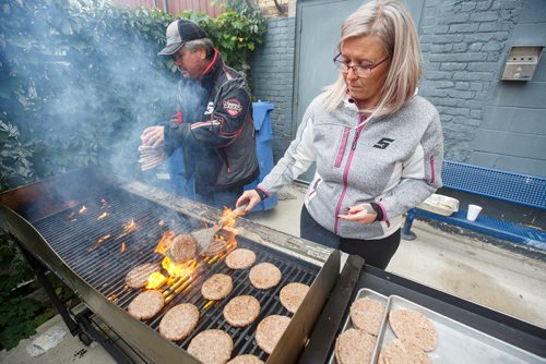 MIKE DEAL / WINNIPEG FREE PRESS
(from left) Glen Urbanski and Crystal Fear help out during a BBQ at the Lighthouse Mission  Saturday afternoon. Lighthouse Mission and the Exchange District Pharmacy hosted the BBQ in an effort to provide health information, advice, and resources to members of the city's neediest community.
180922 - Saturday, September 22, 2018.