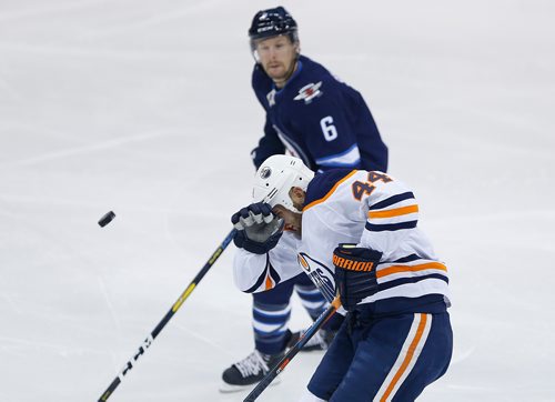 JOHN WOODS / WINNIPEG FREE PRESS
Edmonton Oilers' Zack Kassian (44) get hit with a puck as Winnipeg Jets' Cameron Schilling (6) looks on during first period pre-season NHL action in Winnipeg on Sunday, September 23, 2018.