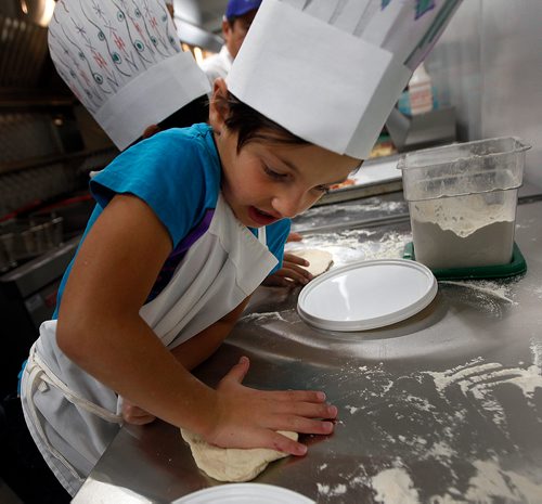 PHIL HOSSACK / WINNIPEG FREE PRESS - STAND-UP - 7 yr old Jaerden Peters works her pizza dough before getting it into the oven Monday evening at Capitol Grill on Broadway resteraunt during a Variety Children's CHarity of Manitoba event for about 60 special needs kids and their parents. See release and Doug's story.   - Sept 24, 2018