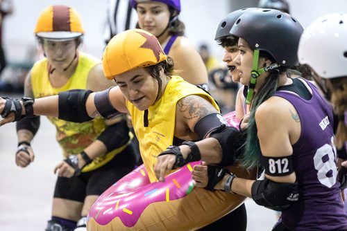 SUBMITTED PHOTO / MATT DUBOFF

Skater Sara 'Eggs Benny' Bennet jams in an inflatable doughnut during the Winnipeg Roller Derby League's FUNraiser game in support of the North Point Douglas Women's Centre on Sept. 7, 2018. (See Social Page)