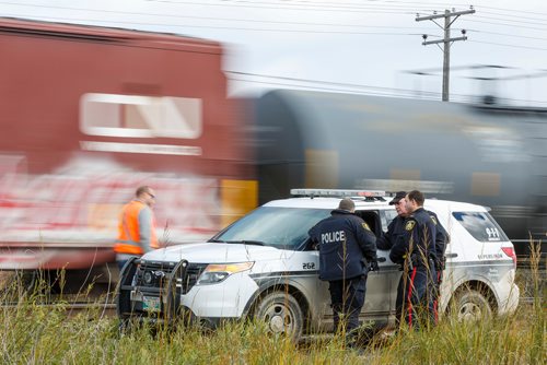 MIKE DEAL / WINNIPEG FREE PRESS
Police at the scene of a CN rail line where a person was hit by a train close to Wilks Ave. and Shaftesbury Blvd. Friday morning.
180928 - Friday, September 28, 2018.