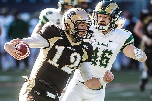 MIKE DEAL / WINNIPEG FREE PRESS
Manitoba Bisons' quarterback Des Catellier (12) runs the ball while Regina Rams Bole Benkic (46) rushes in for a tackle during a play in the second quarter against the Regina Rams at Investors Group Field.
The Regina Rams won in overtime 32-31 over the Manitoba Bisons in Canada West university football action at Investors Group Field Saturday afternoon.
180929 - Saturday, September 29, 2018.