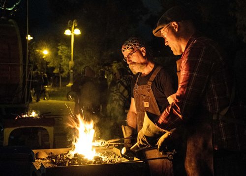 MIKE SUDOMA / WINNIPEG FREE PRESS
(left to right) Hubert Verrier and Steve Ducharme of Cloverdale Forge crafting various trinkets and tools during the Nuit Blanche Festival Saturday night. September 29, 2018