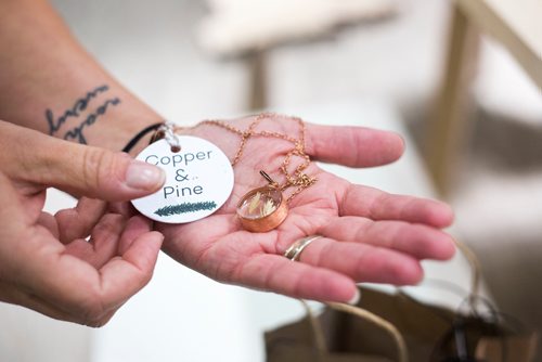 MIKAELA MACKENZIE / WINNIPEG FREE PRESS
Melissa Penner of Made Here sets up items, which will be opening at the Portage and Main Concourse this Thursday, displays products from local makers and artisans with a portion of proceeds going to children's charities in Winnipeg on Wednesday, Oct. 3, 2018.  Winnipeg Free Press 2018.