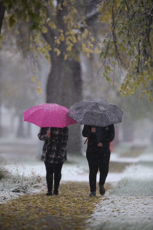 TREVOR HAGAN / WINNIPEG FREE PRESS
Two people walk along Clifton Street during a snowfall, Wednesday, October 3, 2018.