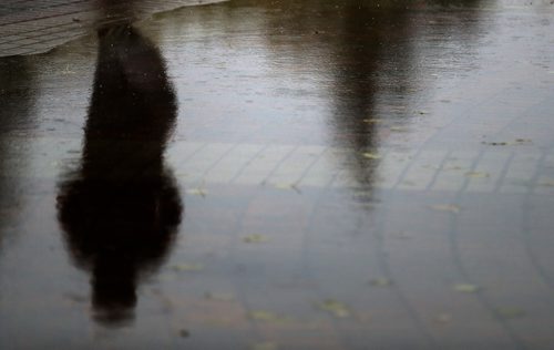 TREVOR HAGAN / WINNIPEG FREE PRESS
Shadow of a man walking past a rainy puddle, Wednesday, October 3, 2018.