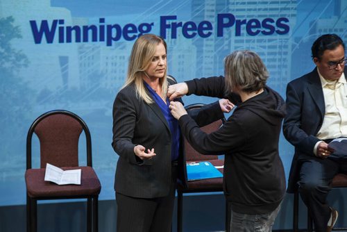 MIKE DEAL / WINNIPEG FREE PRESS
Jenny Motkaluk has a microphone attached to her blazer before the start of the WinnipegREALTORS all-candidates forum held at the Culturel Centre Franco Manitobain Thursday evening.
181004 - Thursday, October 04, 2018.