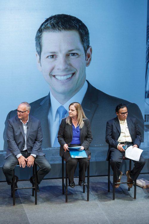 MIKE DEAL / WINNIPEG FREE PRESS
(from left) Tim Diack, Jenny Motkaluk, and Venkat Machiraju, take a seat while images of the candidates are shown on a large screen before the start of the WinnipegREALTORS all-candidates forum held at the Culturel Centre Franco Manitobain Thursday evening.
181004 - Thursday, October 04, 2018.