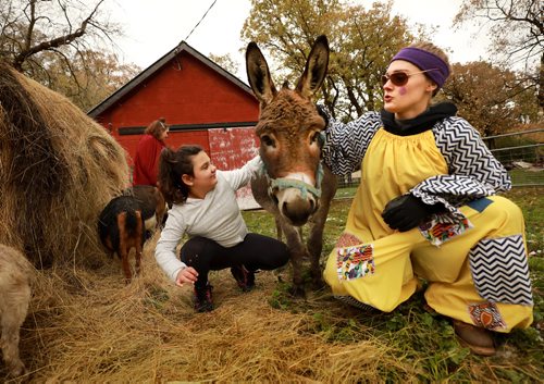 RUTH BONNEVILLE / WINNIPEG FREE PRESS

Standup photo 

Emma-Lynn Zamkotowich (7yrs), enjoys petting animals in the petting zoo area with Tacky T the clown at Six Pines attractions Saturday.  Six Pines opened it door for  its 20th Halloween season with petting zoo, hayrides halloween haunts this weekend. 

October 6th, 2018