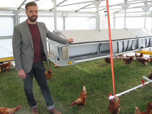 Canstar Community News Sept. 19, 2018 - Ukko Robotics co-founder Daniel Badiou stands inside one of the Rova autonomous poultry tractors displayed at a launch on Sept. 19. (ANDREA GEARY/CANSTAR COMMUNITY NEWS)