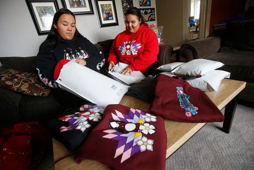 JOHN WOODS / WINNIPEG FREE PRESS
Crissy Slater, left, and her daughter Ariel Spence, owners of Red Road Clothing pack some of their clothing orders in their home Tuesday, October 8, 2018. The couple started the indigenous themed clothing line consisting of sweatshirts, t-shirts, skirts and blankets in their home to help fund Ariel's school trip to Italy. They expect to gross $300,000 in sales this year.