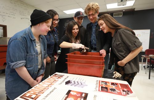 RUTH BONNEVILLE / WINNIPEG FREE PRESS

Green Page

Nelson McIntyre high school teacher, Michelle Naomi, heads up the schools green team and has a vermicompost box in her classroom which she gets the kids involved in maintaining to compost waste.

Names of students part of green team.
Logan Wiehe (left, bk hat), Kaitlyn McKenzie, Dakota Humphrey (cap), Jake Bell (tall, red hair) and Sky McLean (right, long hair).  Teacher, Michelle Naomi, in centre.  


The story is on vermicomposting which is essentially indoor composting using earth worms that are put in the compost bin with the food that is being composted and break the food down, and then the worm's waste is used as fertilizer. 

See story. 

October 9th, 2018