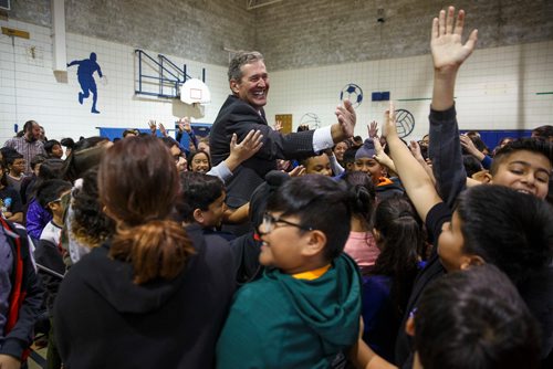 MIKE DEAL / WINNIPEG FREE PRESS
After announcing a new kindergarten to Grade 8 school in Waterford Green, Premier Brian Pallister high-fives a crowd of students in the gym at Meadows West School Thursday morning. 
The 76,430-sq.-ft. school will be located at Jefferson Avenue east of King Edward Street and will be open by September 2020.
181011 - Thursday, October 11, 2018.