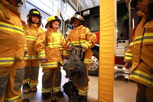 RUTH BONNEVILLE / WINNIPEG FREE PRESS

Standup photo

Grade six students, Sofia Marchenko (left, centre, yellow helmet) and Fifehanmi Abraham-Ajayi, along with their classmates from Hedge Middle School, try on  gear worn by firefighters in the field at Number 11 Fire Station Thursday.  The outing was in honour of the International Day of the Girl which was being recognized by the Winnipeg Fire Paramedic Service (WFPS) partnered with the Government of Manitobas Status of Women which hosted groups of Winnipeg girls at four WFPS locations in Winnipeg.  The purpose of these visits was to ensure young girls know that careers in the Fire and Paramedic Service are within their grasp.


More Info below: 
Approximately 100 sixth grade girls from four Winnipeg schools had the opportunity to participate in WFPS station tours, ask questions to female responders and try their hand at a variety of drills and demonstrations, including learning about CPR, trying on firefighter turn out gear and learning stretcher and hose handling skills.

Today is International Day of the Girl, and this years theme centres around preparing girls for the workforce, said Manitoba Sustainable Development Minister Rochelle Squires, minister responsible for the status of women. This event reminds us that no career goal is off limits for girls, including the Winnipeg Fire and Paramedic Service. I hope the girls participating today have fun, make new friends and come away with greater confidence in their abilities.

Currently, within the WFPS firefighting ranks, approximately five per cent of staff identify as female. Within EMS, that number jumps to approximately 35 per cent. Research states that many young people start leaning towards their particular career interests by approximately 12 years old, which is why todays event is aimed at girls of this age.

Standup photo 

October 11, 2018