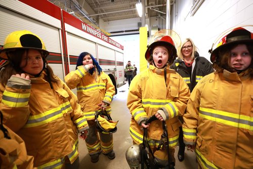 RUTH BONNEVILLE / WINNIPEG FREE PRESS

Standup photo

Grade six student, Zola Desjarlais, shows her surprise of the weight of a oxygen tank worn by firefighters while trying on gear along with her classmates from Hedge Middle School, at Number 11 Fire Station Thursday.  The outing was in honour of the International Day of the Girl which was being recognized by the Winnipeg Fire Paramedic Service (WFPS) partnered with the Government of Manitobas Status of Women which hosted groups of Winnipeg girls at four WFPS locations in Winnipeg.  The purpose of these visits was to ensure young girls know that careers in the Fire and Paramedic Service are within their grasp.


More Info below: 
Approximately 100 sixth grade girls from four Winnipeg schools had the opportunity to participate in WFPS station tours, ask questions to female responders and try their hand at a variety of drills and demonstrations, including learning about CPR, trying on firefighter turn out gear and learning stretcher and hose handling skills.

Today is International Day of the Girl, and this years theme centres around preparing girls for the workforce, said Manitoba Sustainable Development Minister Rochelle Squires, minister responsible for the status of women. This event reminds us that no career goal is off limits for girls, including the Winnipeg Fire and Paramedic Service. I hope the girls participating today have fun, make new friends and come away with greater confidence in their abilities.

Currently, within the WFPS firefighting ranks, approximately five per cent of staff identify as female. Within EMS, that number jumps to approximately 35 per cent. Research states that many young people start leaning towards their particular career interests by approximately 12 years old, which is why todays event is aimed at girls of this age.

Standup photo 

October 11, 2018