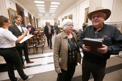 JOHN WOODS / WINNIPEG FREE PRESS
Christine and Ken Waddell, owners of Neepawa Banner and Press, express their frustration as other people sign a petition as they wait for a committee meeting to start at the Manitoba Legislature Thursday, October 11, 2018. Delays by politicians led to a delay in committee meetings.