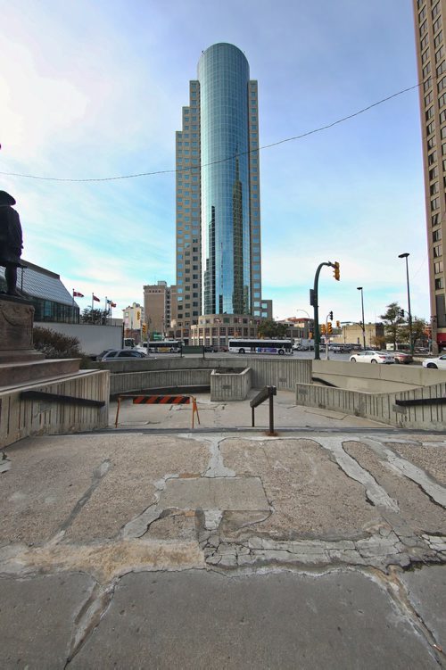 MIKE DEAL / WINNIPEG FREE PRESS
The courtyard at the Bank of Montreal corner of Portage and Main is showing its age with surging concrete pavement and awkwardly patched cracks. 
181012 - Friday, October 12, 2018