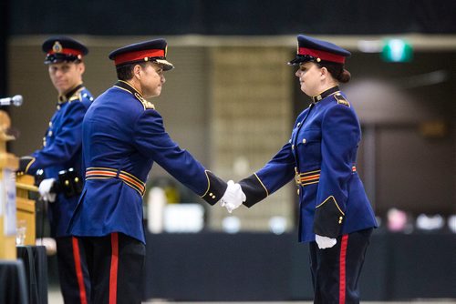 MIKAELA MACKENZIE / WINNIPEG FREE PRESS
Constable Brittany Goranson (right) shakes hands with Chief Danny Smyth at the graduation ceremony for recruit class 161 and 161 lateral takes place at the RBC Convention Centre in Winnipeg on Friday, Oct. 12, 2018. 
Winnipeg Free Press 2018.