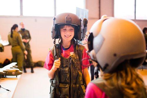 MIKAELA MACKENZIE / WINNIPEG FREE PRESS
Anneka van Egdom smiles at Emma Wall as they try on gear at aviation day at the Royal Aviation Museum of Western Canada in Winnipeg on Saturday, Oct. 13, 2018. 
Winnipeg Free Press 2018.