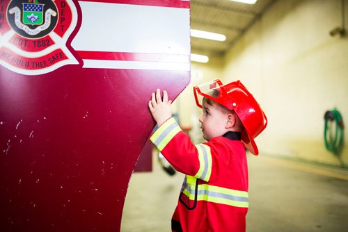 MIKAELA MACKENZIE / WINNIPEG FREE PRESS
Cohen Ateah, three, closes the door of the fire truck after "driving" it at station #22 on open fire hall day as part of fire prevention week in Winnipeg on Saturday, Oct. 13, 2018. 
Winnipeg Free Press 2018.