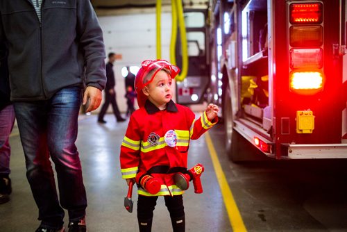MIKAELA MACKENZIE / WINNIPEG FREE PRESS
Cohen Ateah, three, takes a look at the fire truck at station #22 on open fire hall day as part of fire prevention week in Winnipeg on Saturday, Oct. 13, 2018. 
Winnipeg Free Press 2018.