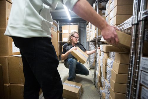 MIKAELA MACKENZIE / WINNIPEG FREE PRESS
Donnie Smith, assistant manager (centre), unpacks inventory in the vault with store manager Chad LaPointe at the Delta 9 cannabis store in Winnipeg on Tuesday, Oct. 16, 2018. Smith estimates that there is about 50,000 grams of cannabis in the vault at this time.
Winnipeg Free Press 2018.