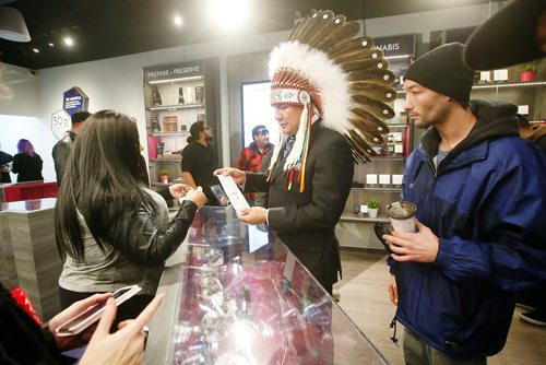 JOHN WOODS / WINNIPEG FREE PRESS
Onekanaw Christian Sinclair, Opaskwayak Cree Nation makes the first purchase at the opening of Meta Cannabis Supply Co Wednesday, October 17, 2018. Opaskwayak Cree Nation is a major shareholder of National Access Cannabis.